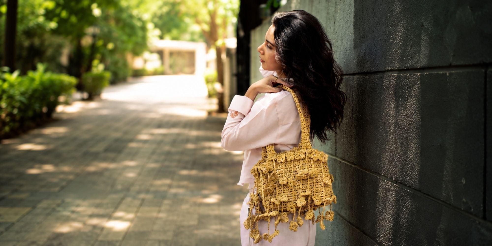"Handcrafted raffia shoulder bag outdoor.