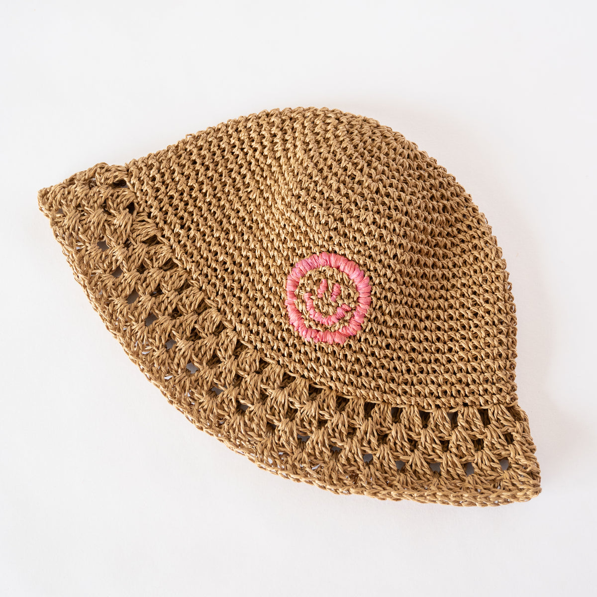Close-up of Dusty Pink Raffia Bucket Hat, handwoven natural straw texture