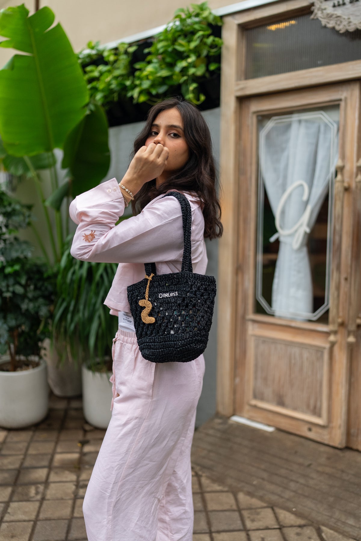 Personalised raffia bag with gold crochet S initial keychain.